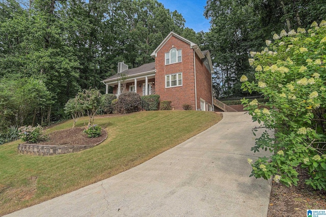 1813 Southpointe Cir, Hoover, AL 35244 - view of front of home featuring driveway, brick siding, a chimney, and a front yard