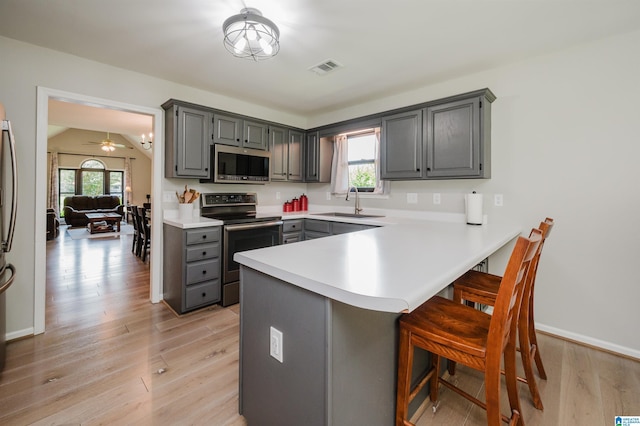 5904 Russet Meadows Way, Helena, AL 35244 - kitchen featuring stainless steel appliances, gray cabinetry, a peninsula, a kitchen breakfast bar, and healthy amount of natural light