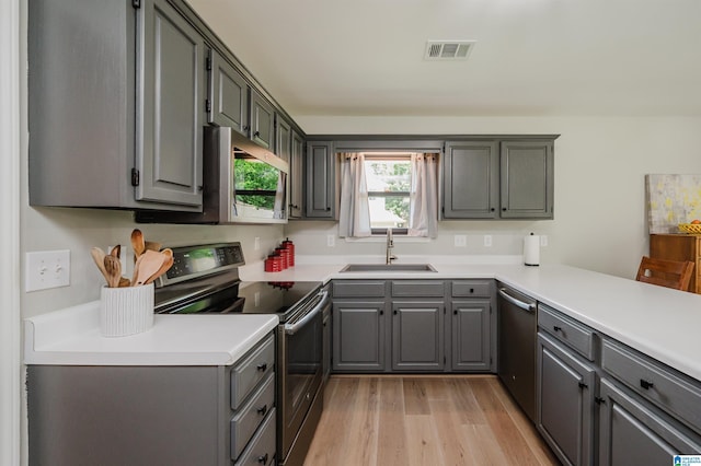 5904 Russet Meadows Way, Helena, AL 35244 - kitchen featuring stainless steel appliances, gray cabinetry, light wood-style flooring, and light countertops