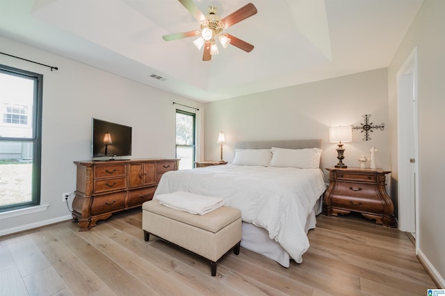 5904 Russet Meadows Way, Helena, AL 35244 - bedroom with light wood finished floors, a raised ceiling, and a ceiling fan