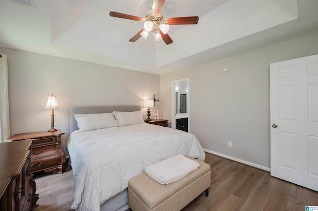 5904 Russet Meadows Way, Helena, AL 35244 - bedroom featuring a raised ceiling, wood finished floors, ensuite bathroom, and a ceiling fan