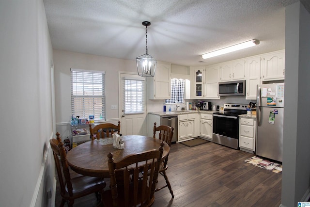 1822 Oakleaf Ln, Center Point, AL 35215 - kitchen featuring stainless steel appliances, dark wood-style flooring, white cabinets, light countertops, and a textured ceiling