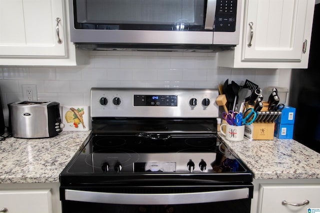 1822 Oakleaf Ln, Center Point, AL 35215 - kitchen with appliances with stainless steel finishes, white cabinets, and decorative backsplash