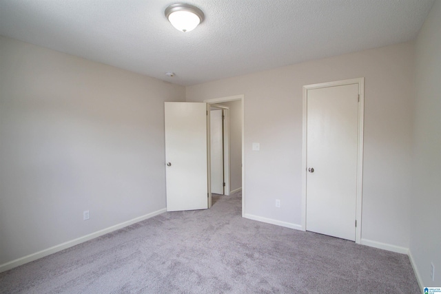 1822 Oakleaf Ln, Center Point, AL 35215 - unfurnished bedroom featuring carpet floors and a textured ceiling