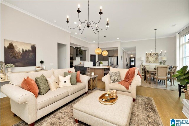 4549 Brexton St, Trussville, AL 35173 - living room featuring a chandelier, recessed lighting, light wood-style floors, and ornamental molding