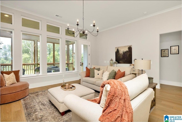 4549 Brexton St, Trussville, AL 35173 - living room with a chandelier, ornamental molding, and light wood-style floors
