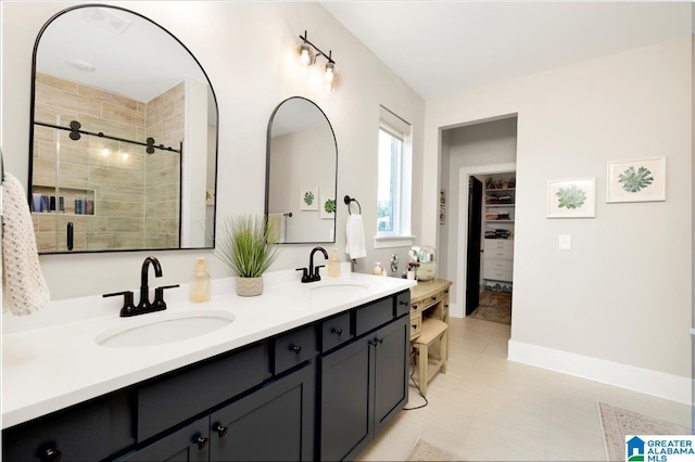 4549 Brexton St, Trussville, AL 35173 - bathroom featuring double vanity, a shower stall, a walk in closet, and tile patterned flooring