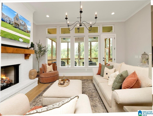 4549 Brexton St, Trussville, AL 35173 - living area with wood finished floors, a chandelier, crown molding, a fireplace, and recessed lighting