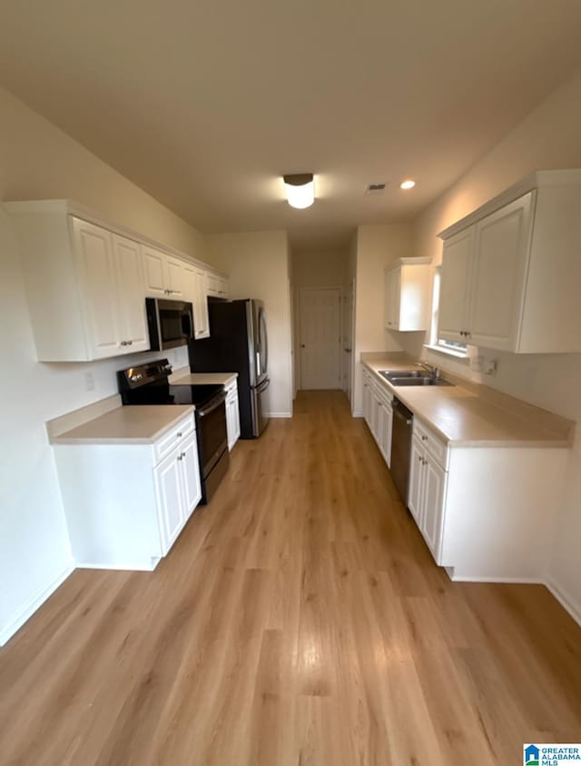 2312 Dunbar Cir, Moody, AL 35004 - kitchen featuring stainless steel appliances, light wood-style flooring, light countertops, white cabinetry, and recessed lighting