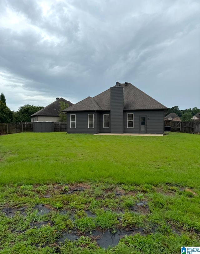 2312 Dunbar Cir, Moody, AL 35004 - rear view of property featuring a chimney, a fenced backyard, and roof with shingles