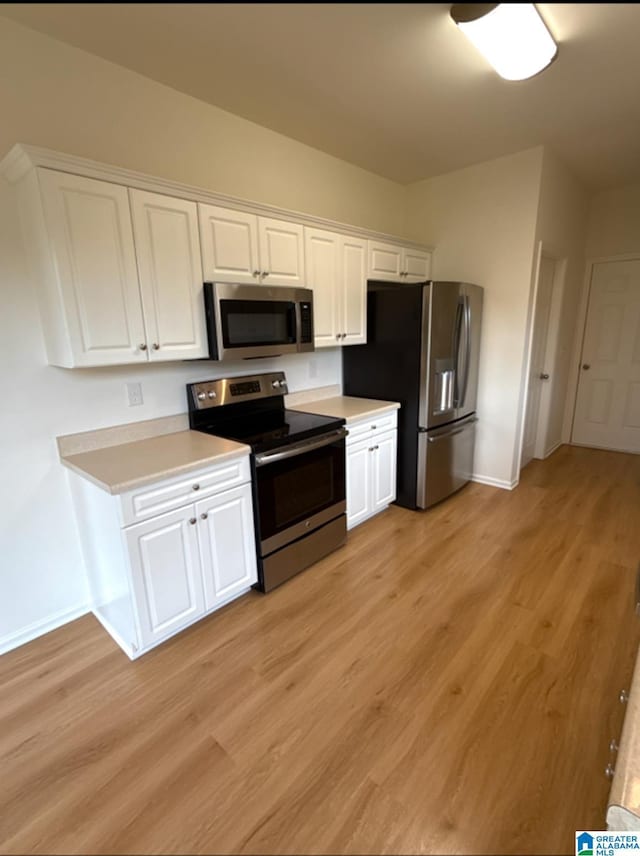 2312 Dunbar Cir, Moody, AL 35004 - kitchen featuring stainless steel appliances, white cabinets, and light wood-style flooring
