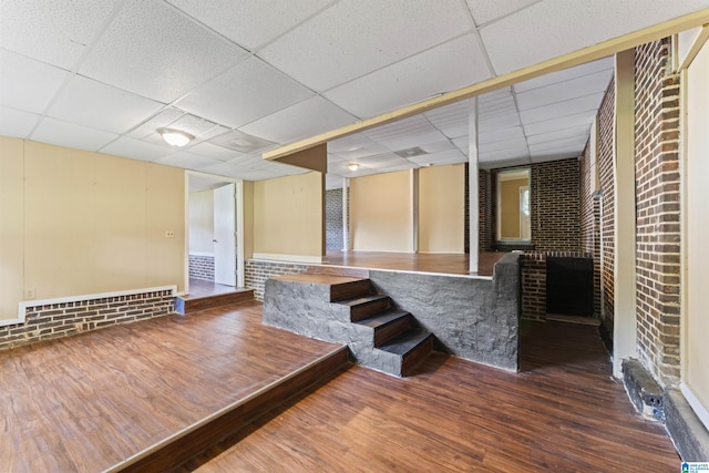 540 Harlem Ave, Hueytown, AL 35023 - spare room featuring wood finished floors, a drop ceiling, and brick wall