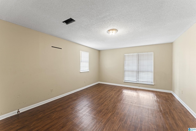 540 Harlem Ave, Hueytown, AL 35023 - empty room with dark wood-style flooring and a textured ceiling