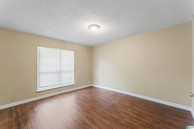 540 Harlem Ave, Hueytown, AL 35023 - unfurnished room with dark wood finished floors and a textured ceiling