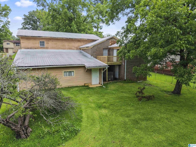 540 Harlem Ave, Hueytown, AL 35023 - rear view of house with a lawn and a metal roof