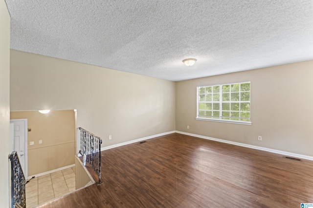 540 Harlem Ave, Hueytown, AL 35023 - unfurnished living room featuring wood finished floors and a textured ceiling