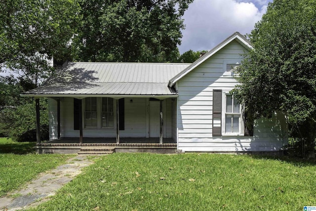 1221 4th Pl, Pleasant Grove, AL 35023 - view of front of home featuring covered porch, a front lawn, and a metal roof