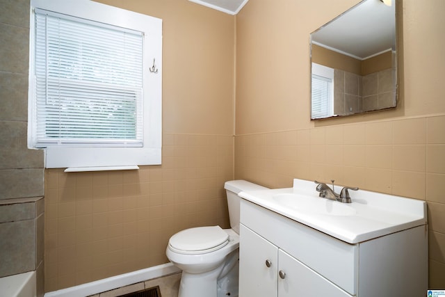 1221 4th Pl, Pleasant Grove, AL 35023 - bathroom featuring tile walls, vanity, ornamental molding, a tub to relax in, and a wainscoted wall