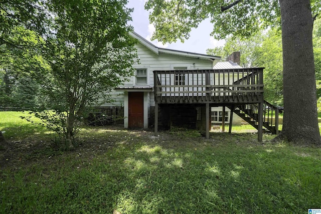 1221 4th Pl, Pleasant Grove, AL 35023 - rear view of property featuring stairway, a wooden deck, a chimney, and a lawn