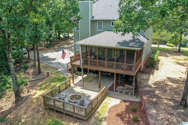 273 Forest Pkwy, Alabaster, AL 35007 - back of property featuring a shingled roof, a chimney, a sunroom, and an outdoor fire pit