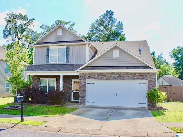 4490 Brookshire Cir, Bessemer, AL 35022 - view of front facade with driveway, an attached garage, board and batten siding, stone siding, and covered porch