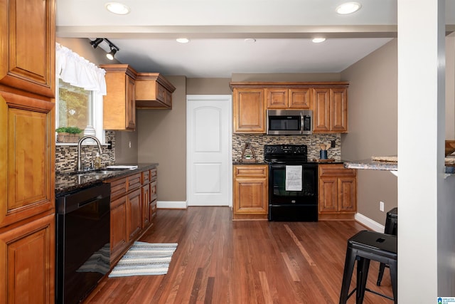 1228 Macqueen Dr, Helena, AL 35080 - kitchen with black appliances, dark stone counters, decorative backsplash, dark wood-style flooring, and recessed lighting