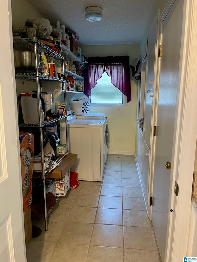 7821 Shriner Dr, Pinson, AL 35126 - laundry area with washing machine and dryer, light tile patterned floors, and a textured ceiling