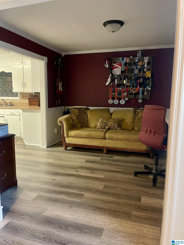 7821 Shriner Dr, Pinson, AL 35126 - living area with ornamental molding, light wood finished floors, and a textured ceiling