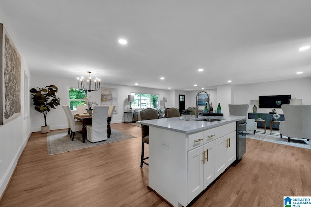 7174 Rowan Rd, Leeds, AL 35094 - kitchen with open floor plan, white cabinets, recessed lighting, light wood-type flooring, and a kitchen island with sink