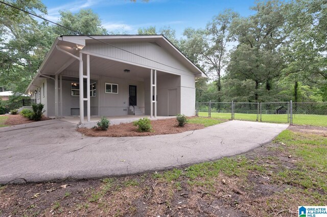 7174 Rowan Rd, Leeds, AL 35094 - view of front facade with asphalt driveway, a gate, a carport, and brick siding
