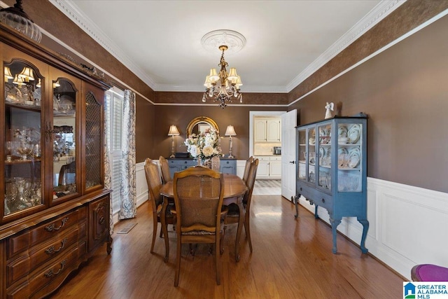 315 Roundabout Dr, Trussville, AL 35173 - dining space with a chandelier, wainscoting, dark wood-style flooring, and ornamental molding