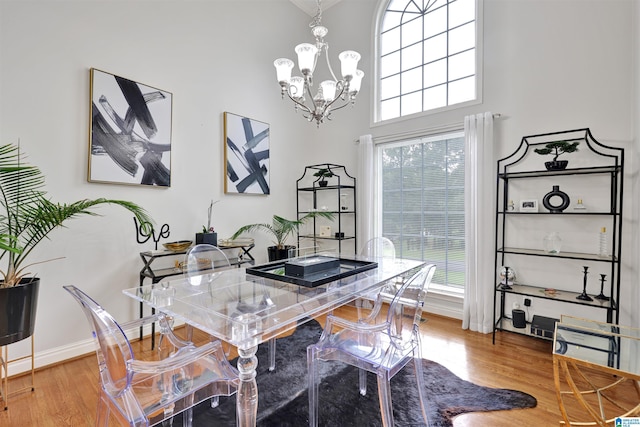 22489 Iron Masters Loop, Mccalla, AL 35111 - dining room with a chandelier, wood finished floors, plenty of natural light, and a towering ceiling