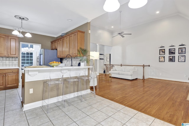 22489 Iron Masters Loop, Mccalla, AL 35111 - kitchen with freestanding refrigerator, light tile patterned floors, light countertops, ceiling fan, and open floor plan