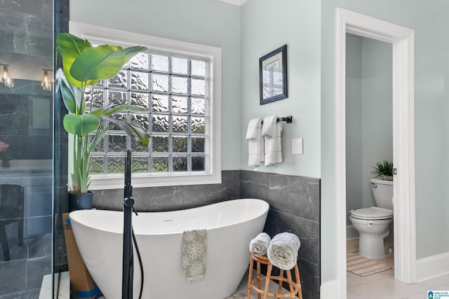 3037 Twelve Stones Rd SE, Owens Cross Roads, AL 35763 - bathroom with plenty of natural light, a freestanding tub, tile walls, and a shower stall