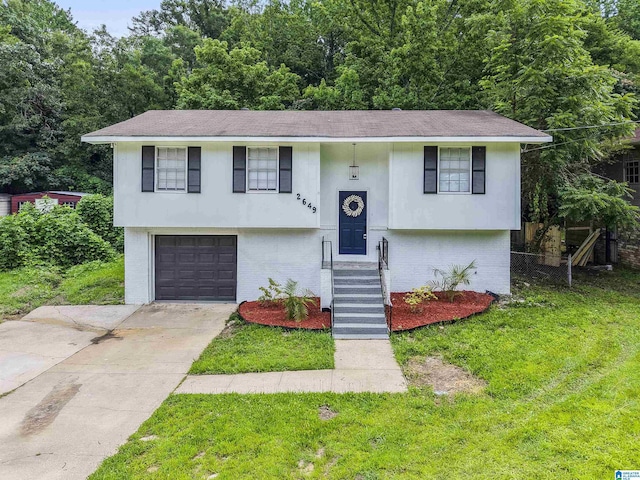 2649 6th St NE, Center Point, AL 35215 - split foyer home with brick siding, concrete driveway, an attached garage, and a shingled roof