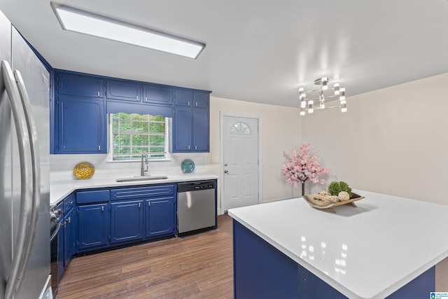 2649 6th St NE, Center Point, AL 35215 - kitchen with appliances with stainless steel finishes, a chandelier, dark wood finished floors, and light countertops