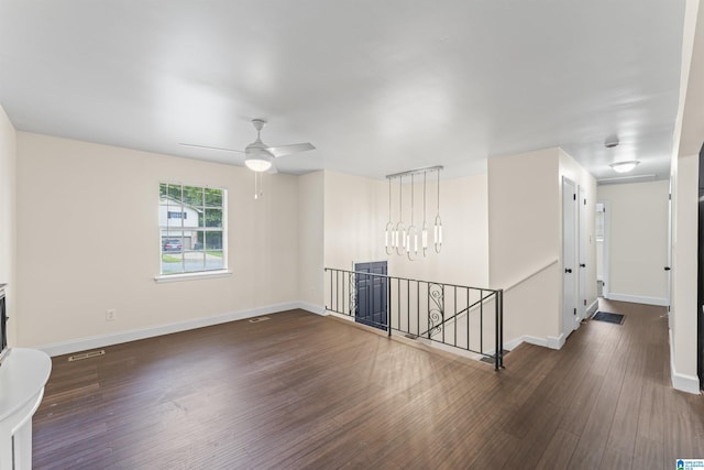 2649 6th St NE, Center Point, AL 35215 - unfurnished room featuring wood finished floors, a chandelier, and a ceiling fan