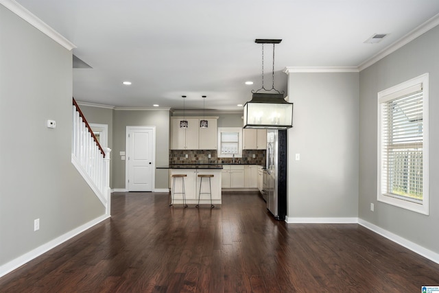 5181 Cruise St, Trussville, AL 35173 - kitchen with recessed lighting, backsplash, dark wood-style floors, a breakfast bar, and dark countertops