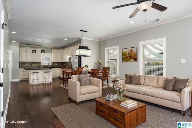5181 Cruise St, Trussville, AL 35173 - living area featuring dark wood-type flooring, a ceiling fan, crown molding, and recessed lighting