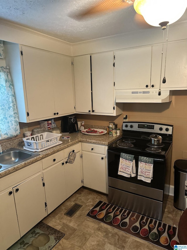 1988 County Rd, Alexander City, AL 35010 - kitchen featuring stainless steel range with electric cooktop, under cabinet range hood, white cabinetry, and a textured ceiling