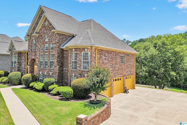 2816 Aster Lake Rd, Helena, AL 35022 - view of side of property with brick siding, an attached garage, a shingled roof, driveway, and a yard
