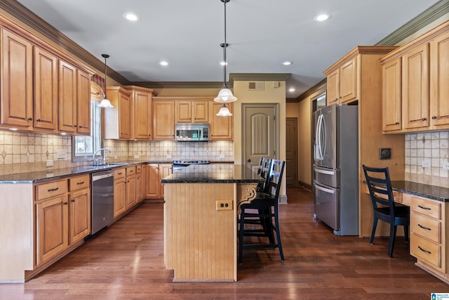 163 River Valley Rd, Helena, AL 35080 - kitchen with appliances with stainless steel finishes, a kitchen island, a breakfast bar area, backsplash, and ornamental molding