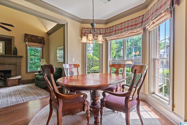 163 River Valley Rd, Helena, AL 35080 - dining area with plenty of natural light, a chandelier, ornamental molding, a tile fireplace, and lofted ceiling