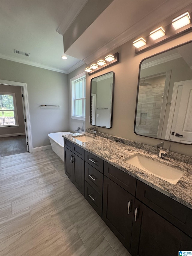 21320 Callie Cir, Mccalla, AL 35111 - bathroom featuring crown molding, double vanity, tiled shower, plenty of natural light, and a freestanding tub