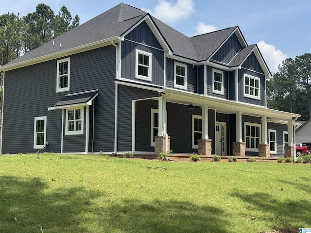 21320 Callie Cir, Mccalla, AL 35111 - craftsman house with a porch, a front yard, a shingled roof, and board and batten siding