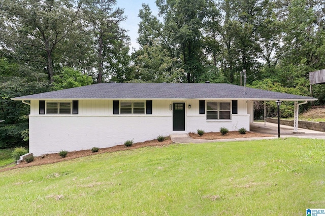 4533 Oak Dr, Pinson, AL 35126 - single story home featuring brick siding, a front lawn, a carport, and roof with shingles