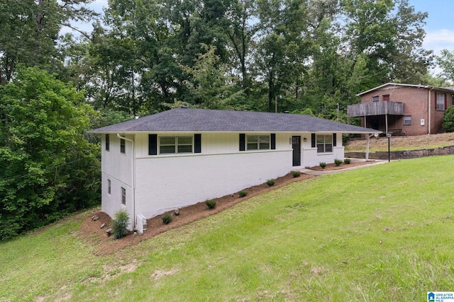 4533 Oak Dr, Pinson, AL 35126 - ranch-style home featuring a front yard, brick siding, and view of wooded area