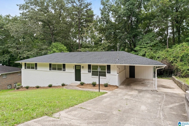 4533 Oak Dr, Pinson, AL 35126 - ranch-style house featuring driveway, a front lawn, a shingled roof, brick siding, and an attached carport