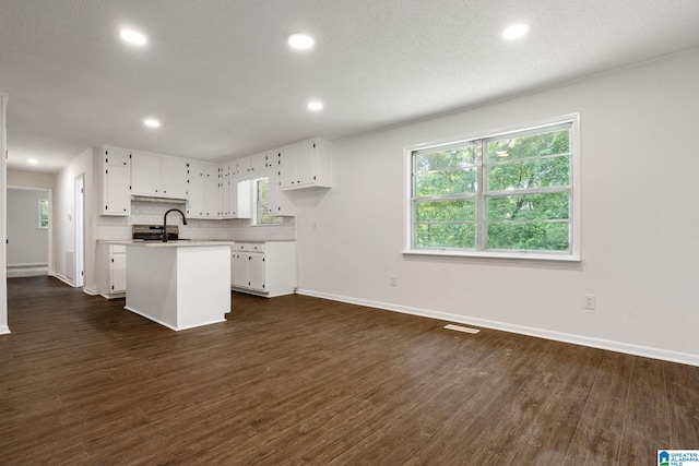 4533 Oak Dr, Pinson, AL 35126 - kitchen featuring light countertops, a kitchen island with sink, white cabinetry, dark wood-type flooring, and recessed lighting