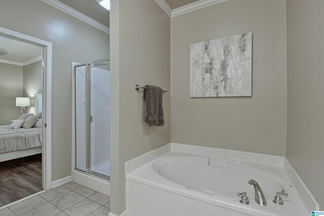 1186 Inverness Cove Way, Hoover, AL 35242 - ensuite bathroom with crown molding, a garden tub, a stall shower, and tile patterned floors